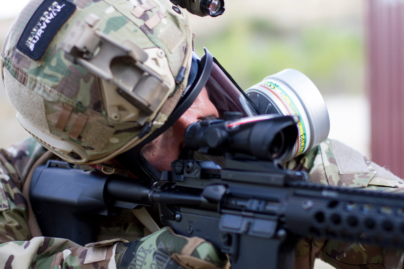 Military man using the CM-6M tactical gas mask with a rifle